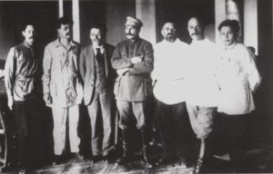 С.М. Аржаков (крайний слева) и М.К. Аммосов (крайний справа) с руководством партии и правительства СССР на XIII cъезде РКПб — И.В. Сталиным, М.И. Калининым, Е.М. Ярославским и др.